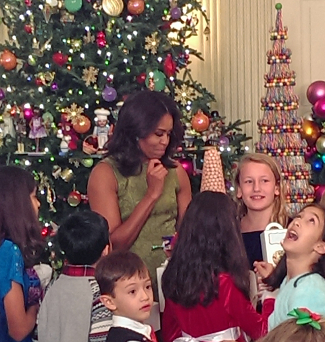 First Lady Michelle Obama visits with children of the armed forces at a holiday event at the White House.