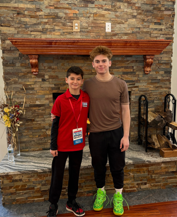 Scholastic Kid Reporter Asher Freije with speed skater Quinn Derheimer. 