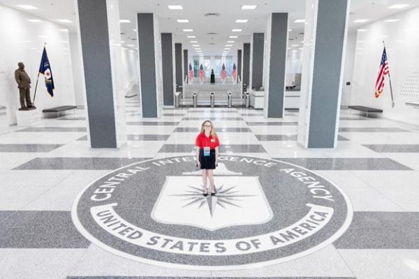 Coco in front of the iconic seal inside CIA headquarters Coco in front of the iconic seal inside CIA headquarters
