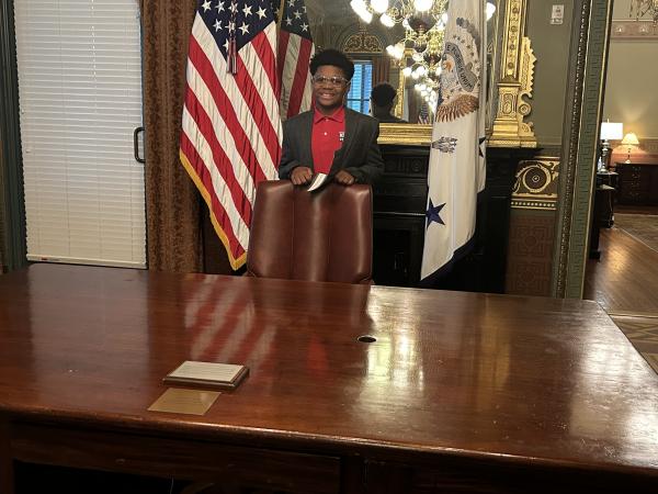 Xander Dorsey pictured behind Theodore Roosevelt’s desk in the Vice President’s Ceremonial Office