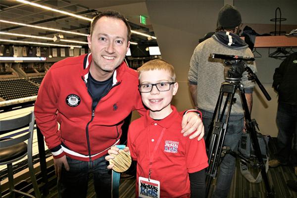 Brandon holds Tyler George's gold medal