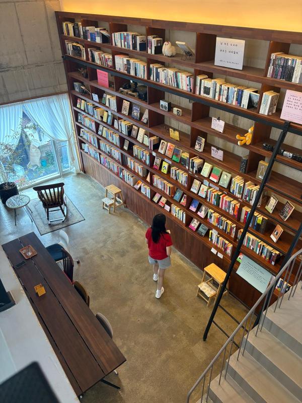 Josephine admiring a wide collection of books that were readable inside the bookstore. There were countless international books for readers to read.  Josephine admiring a wide collection of books that were readable inside the bookstore. There were countless international books for readers to read.