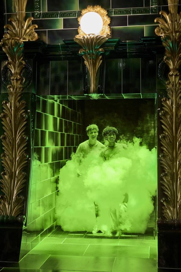 Just like in Harry Potter and the Chamber of Secrets, where Harry first encounters the Floo Network, guests at Epic Universe step through emerald flames and green smoke as part of the ride’s immersive queue at the Ministry of Magic. Just like in Harry Potter and the Chamber of Secrets, where Harry first encounters the Floo Network, guests at Epic Universe step through emerald flames and green smoke as part of the ride’s immersive queue at the Ministry of Magic.