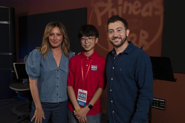 Kid Reporter Aiden An (middle) with Ashley Tisdale (left), who voices Candace, and Vincent Martella (right), who voices Phineas.