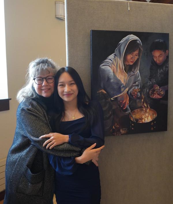 National Gold Medal Winner Lillian Zhou with her art teacher Tracy Wesinger in front of her award-winning painting, “Messages Sent Aflame". 