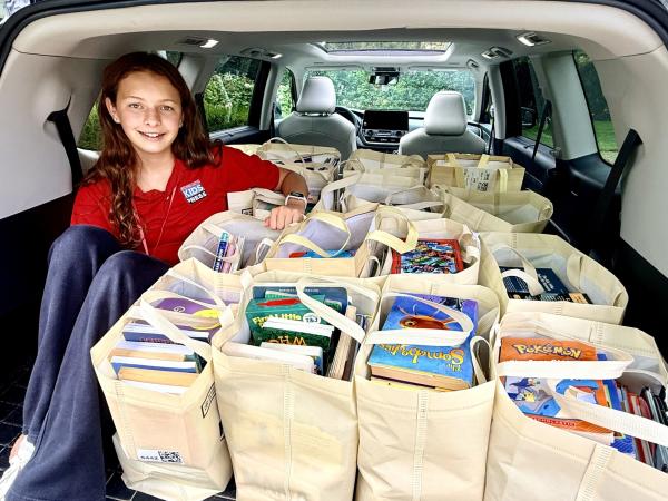 Mika packs donations to be delivered to Bridge of Books. 