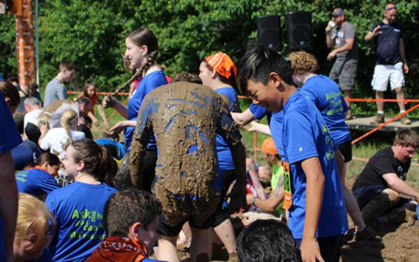 Reporter Ava Park-Matt and other participatns  in the “Muckin’Corral” getting mucked-up before the race begins.