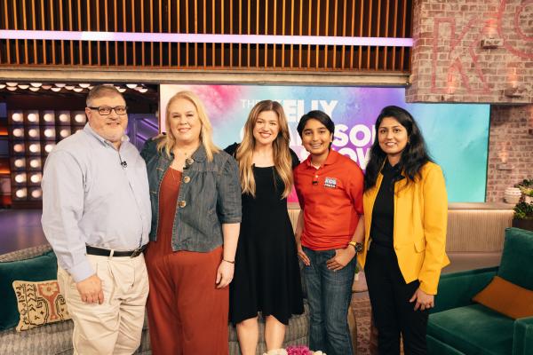 Syd's Book Shack & Boutique co-owners Paul DeJohn and Meredith Daggett, Kelly Clarkson, and Scholastic Kid Reporter Arjun Atluri and Mounika Atluri Syd's Book Shack & Boutique co-owners Paul DeJohn and Meredith Daggett, Kelly Clarkson, and Scholastic Kid Reporter Arjun Atluri and Mounika Atluri