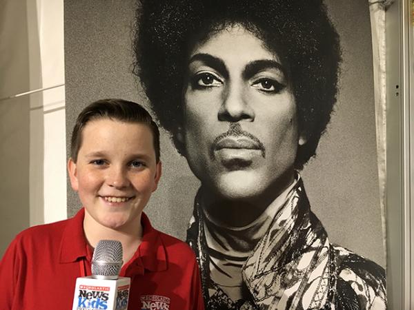 Ryan in front of a Prince poster inside Paisley Park Ryan in front of a Prince poster inside Paisley Park