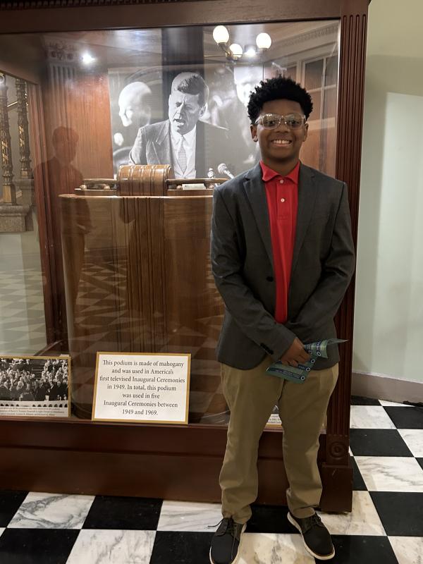 Xander Dorsey pictured in front of the podium President John F. Kennedy used for many of his speeches.