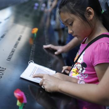 A child learns about the tragedies of 9/11 at the memorial