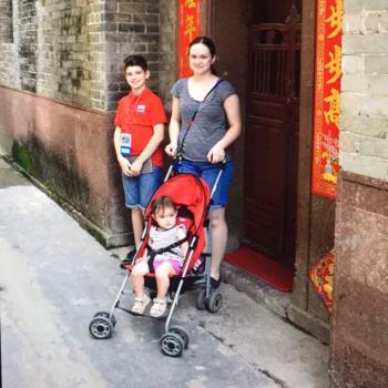 Giona and Sara in front of her family house