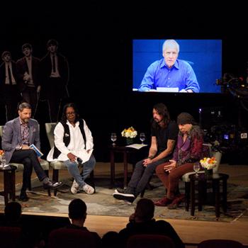 Left to right: Scholastic Vice President Billy DiMichele, Whoopi Goldberg, Dave Grohl, and Stevie Van Zandt talk about the influence of the Beatles at a Scholastic event celebrating the British rock group's influence. Larry Kane shares his thoughts via satellite.