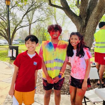 Volunteers Aayush Khadse (middle) and Aanya Gautam (right) help register participants for the Holi festival.