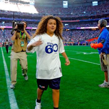 Bobby Sena, winner of this year's NFL PLay 60 Super Kid contest, runs across the field before Super Bowl XLIX.
