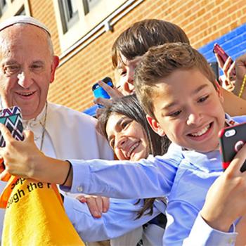 Pope Francis greets students at Our Lady Queen of Angels School in East Harlem on September 25. The Pope got a lesson in how to use smartphones.